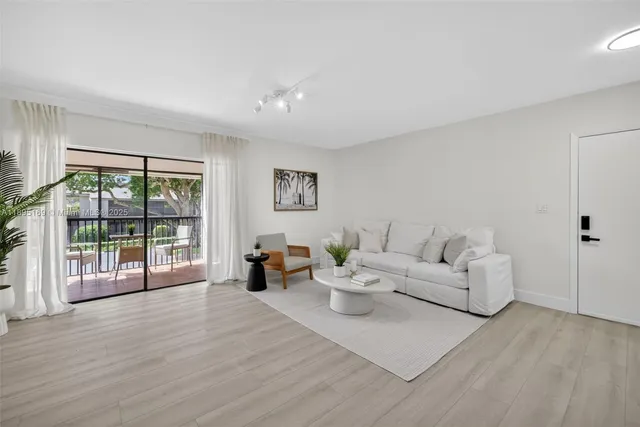 a living room with furniture and large windows