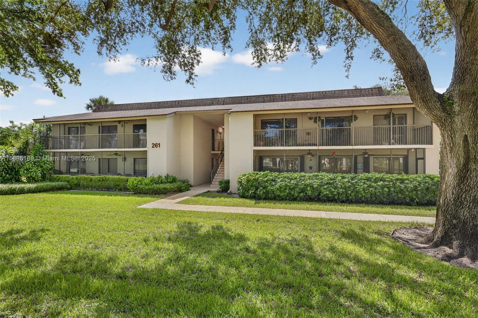 261 Deer Creek Boulevard, Unit 1205 Deerfield Beach, FL 33442 - Photo 7 of 38 a front view of a house with a yard