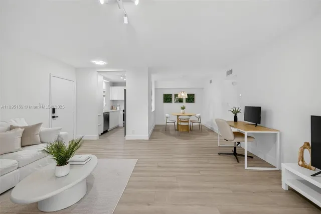 a living room with furniture and a potted plant