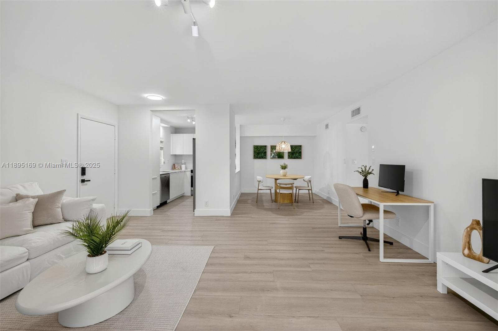 261 Deer Creek Boulevard, Unit 1205 Deerfield Beach, FL 33442 - Photo 9 of 38 a living room with furniture and a potted plant