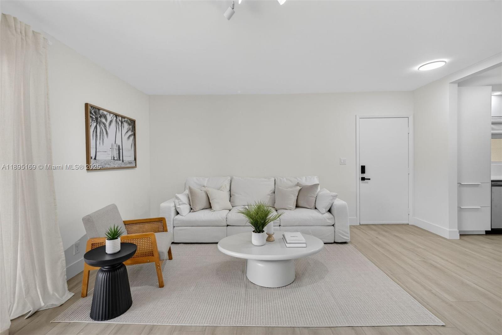 261 Deer Creek Boulevard, Unit 1205 Deerfield Beach, FL 33442 - Photo 10 of 38 a living room with furniture and wooden floor
