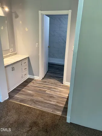 a view of a hallway to closet and wooden floor