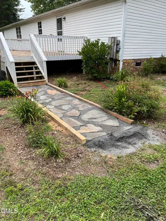 a view of a backyard with plants and a patio