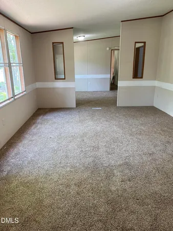 an empty room with windows and entrance