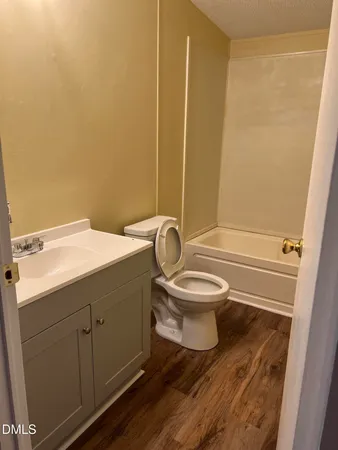 a bathroom with a toilet a sink and bathtub
