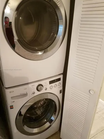 an empty room with wooden floor and fan
