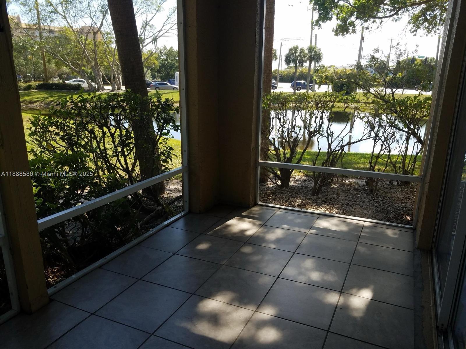 4863 Via Palm Lakes, Unit 806 West Palm Beach, FL 33417 - Photo 14 of 23 a backyard of a house with lots of green space