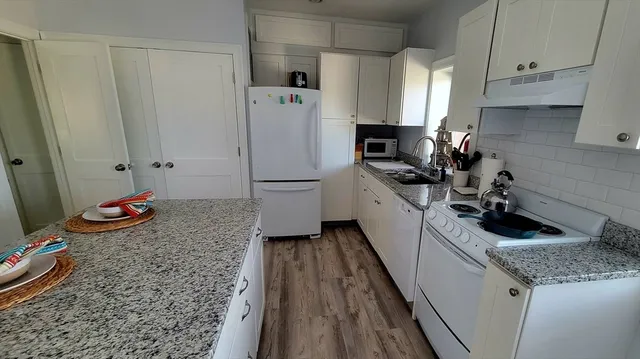 a kitchen with a sink a stove and refrigerator