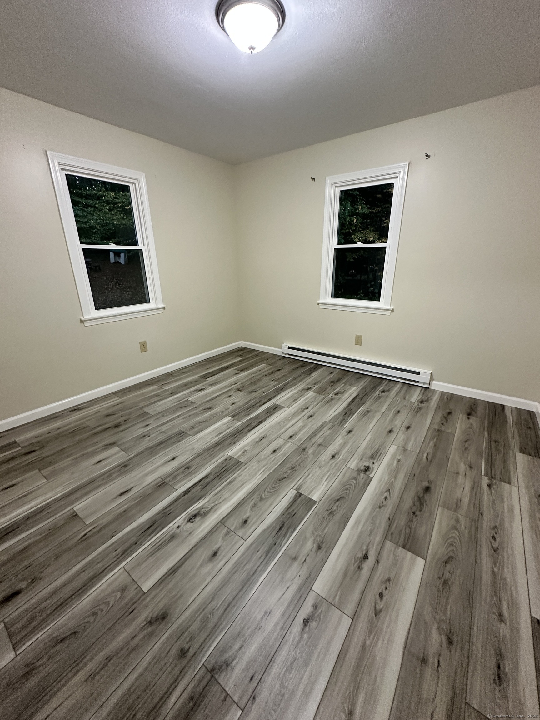 70 Pond Meadow Road Essex, CT 06442 - Photo 11 of 12 a view of an empty room with wooden floor and a window