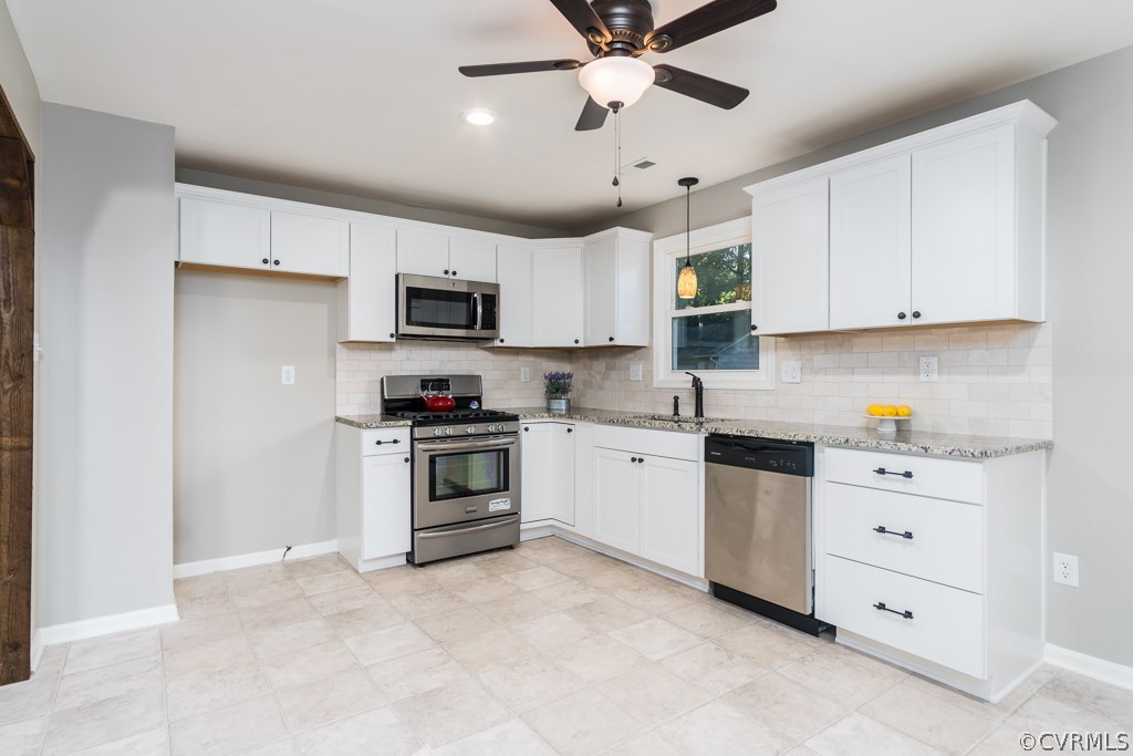 1105 Enon Church Road Chester, VA 23836 - Photo 19 of 34 a kitchen with cabinets stainless steel appliances and a counter space