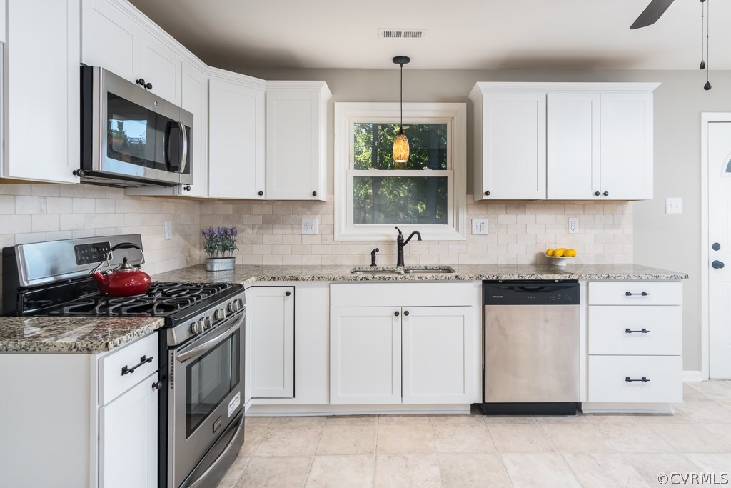 1105 Enon Church Road Chester, VA 23836 - Photo 21 of 34 a kitchen with stainless steel appliances granite countertop a sink a stove a microwave and cabinets