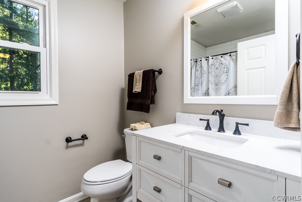 1105 Enon Church Road Chester, VA 23836 - Photo 23 of 34 a bathroom with a toilet a sink a window and mirror