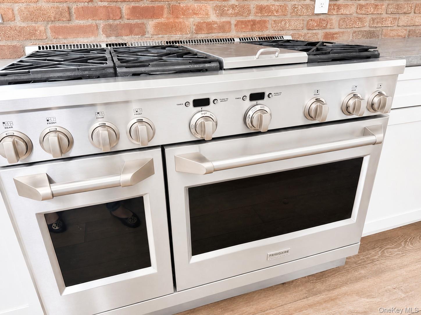 82 Shingle House Road Millwood, NY 10546 - Photo 6 of 6 Professional-grade stainless steel range with gas cooktop, dual ovens, and integrated griddle feature.