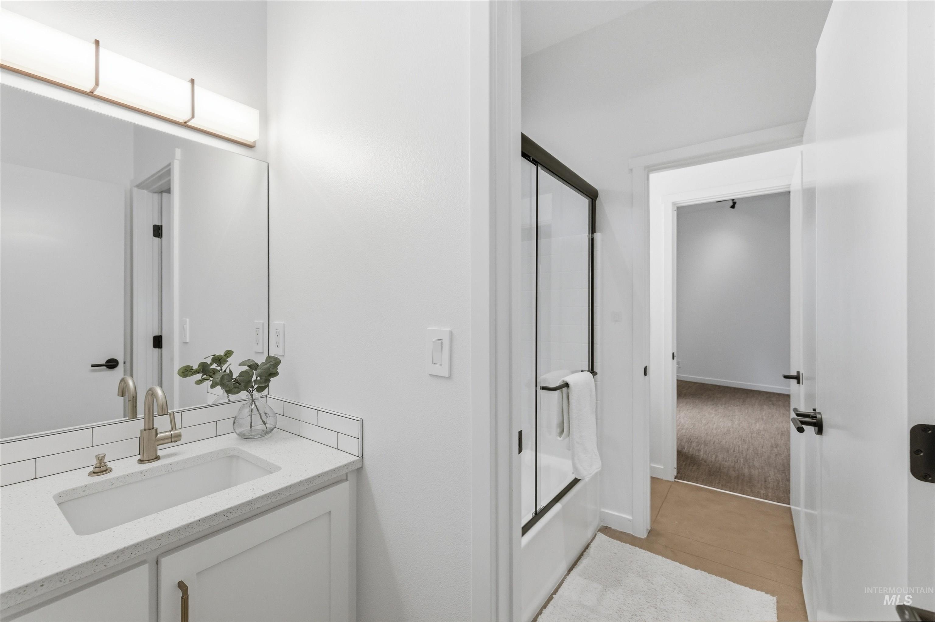 4275 36th Street Boise, ID 83703 - Photo 15 of 50 Full bathroom featuring vanity and bath / shower combo with glass door
