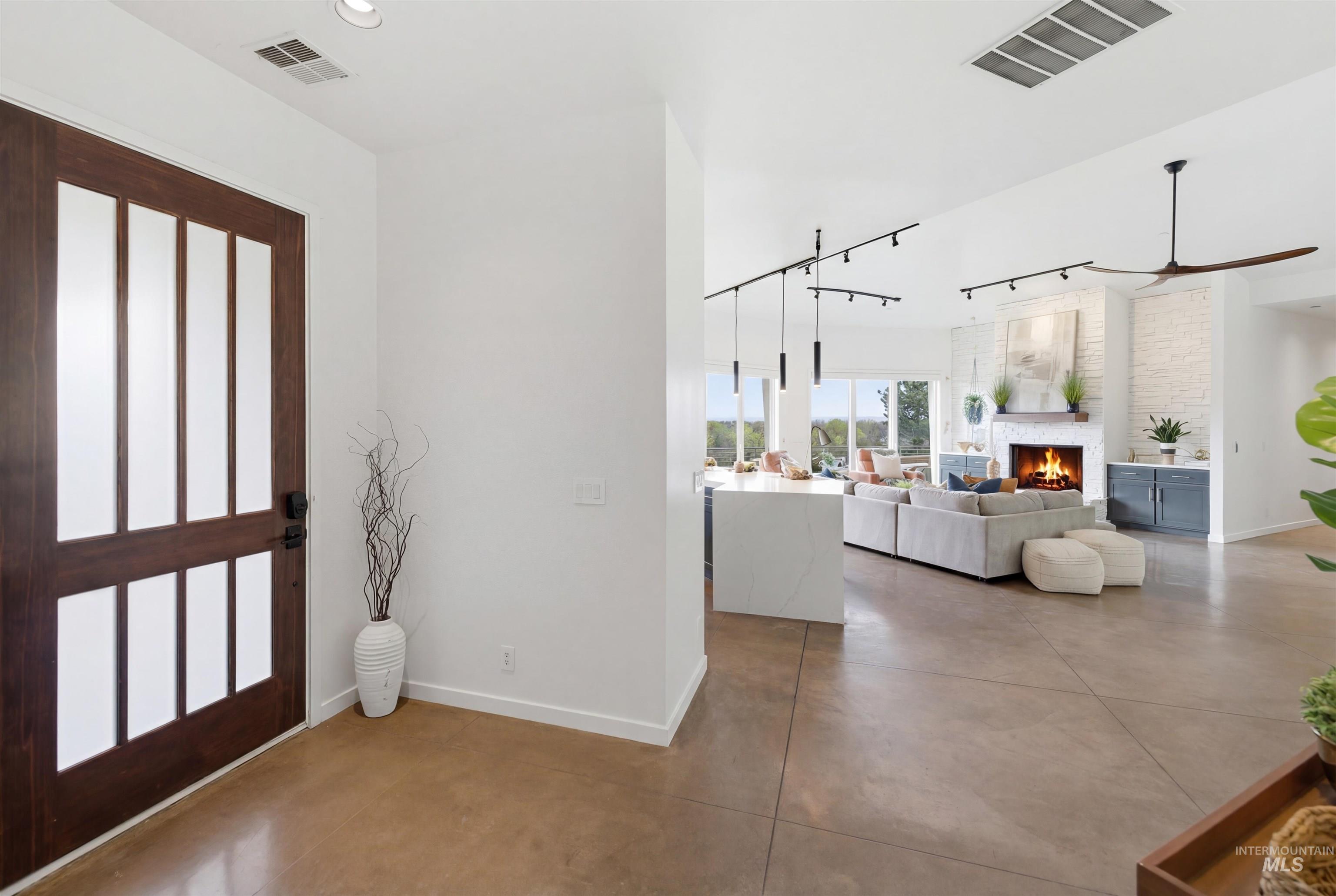 4275 36th Street Boise, ID 83703 - Photo 2 of 50 Entryway with finished concrete floors, a large fireplace, recessed lighting, and a ceiling fan
