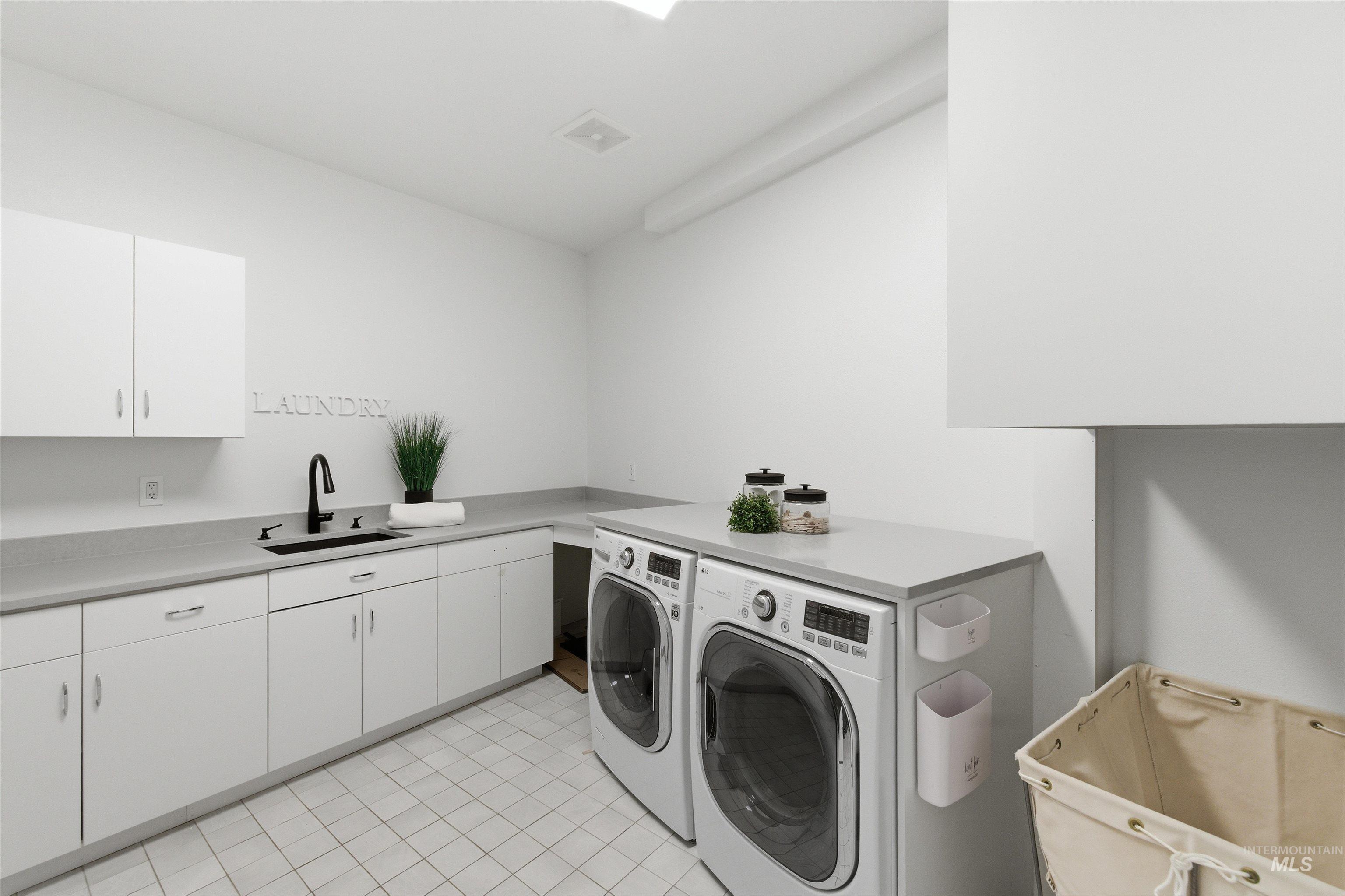 4275 36th Street Boise, ID 83703 - Photo 30 of 50 Laundry area with washer and clothes dryer and cabinet space