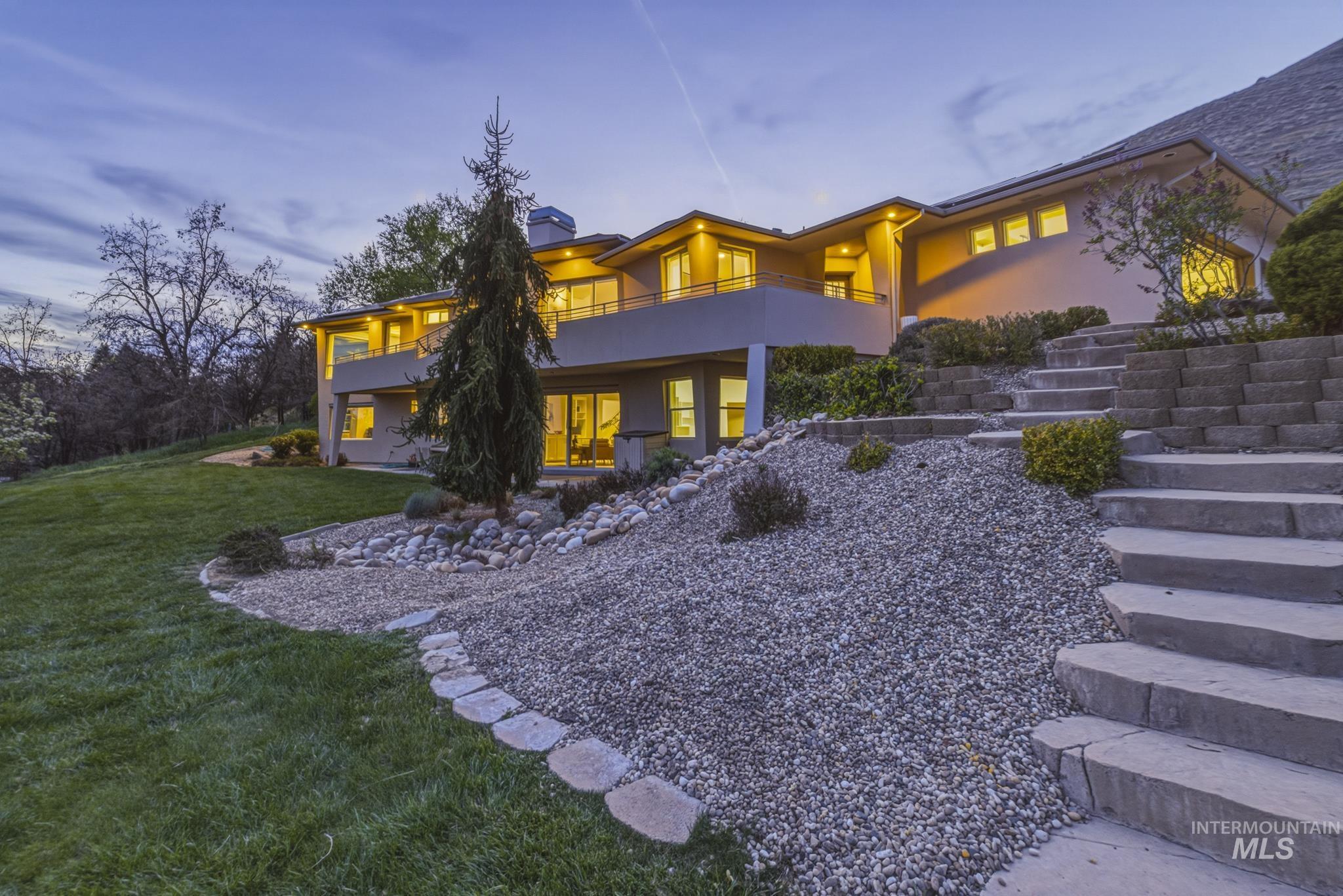 4275 36th Street Boise, ID 83703 - Photo 40 of 50 Back of property with stucco siding, a lawn, a chimney, and a balcony