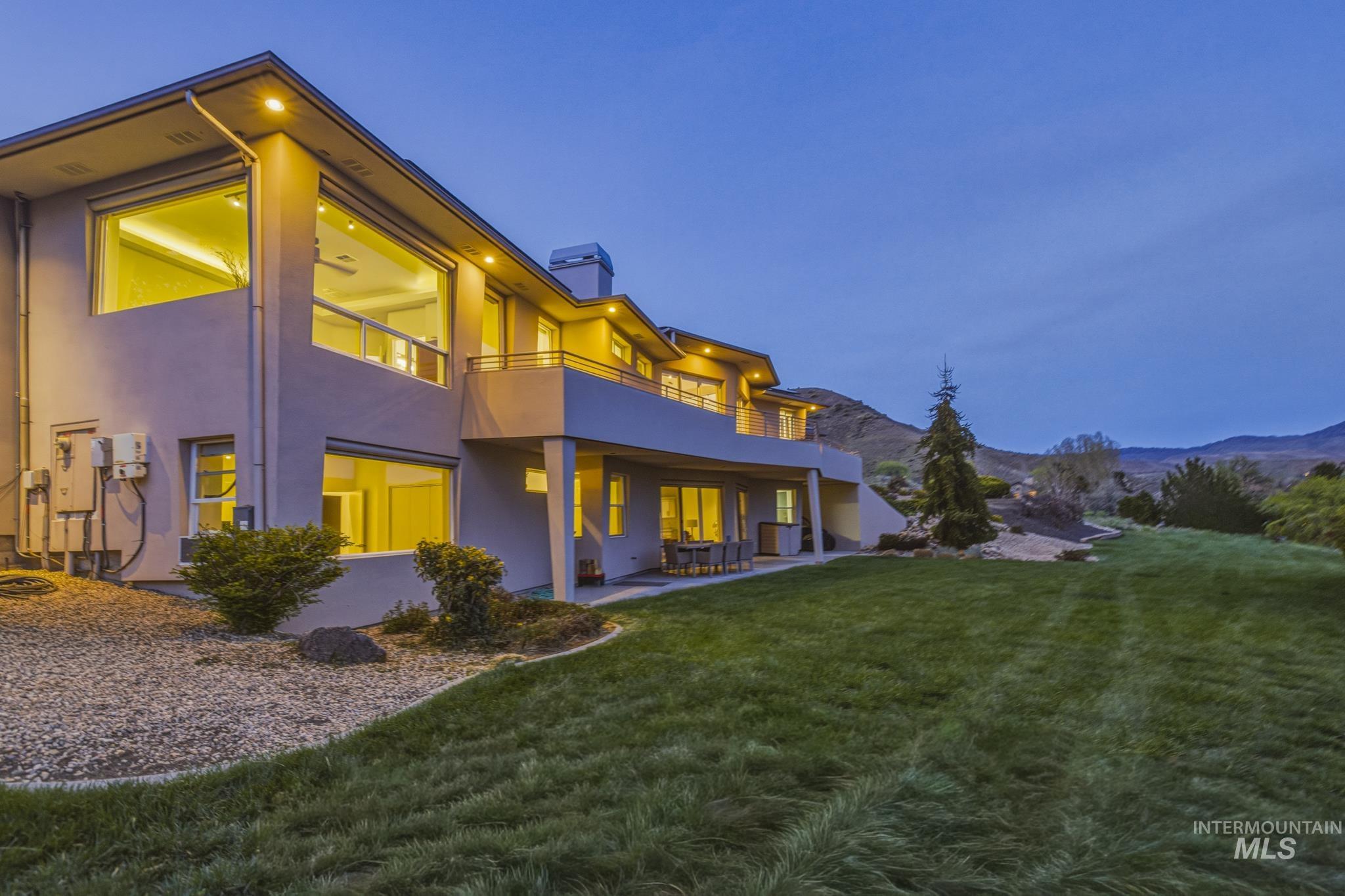 4275 36th Street Boise, ID 83703 - Photo 41 of 50 Back of property featuring a yard, a chimney, a patio area, stucco siding, and a balcony