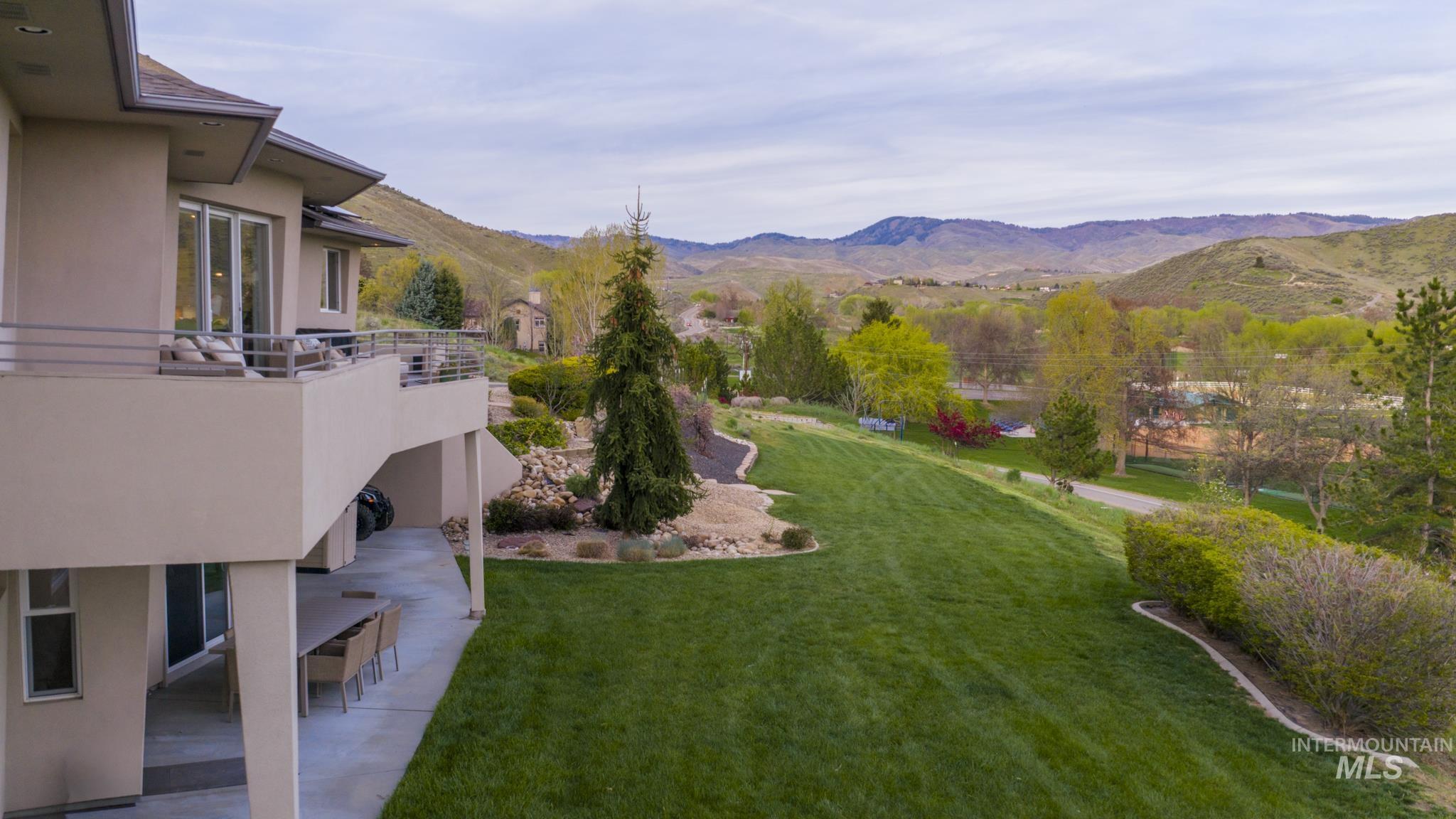4275 36th Street Boise, ID 83703 - Photo 42 of 50 View of green lawn featuring a mountain view, a patio area, and a balcony