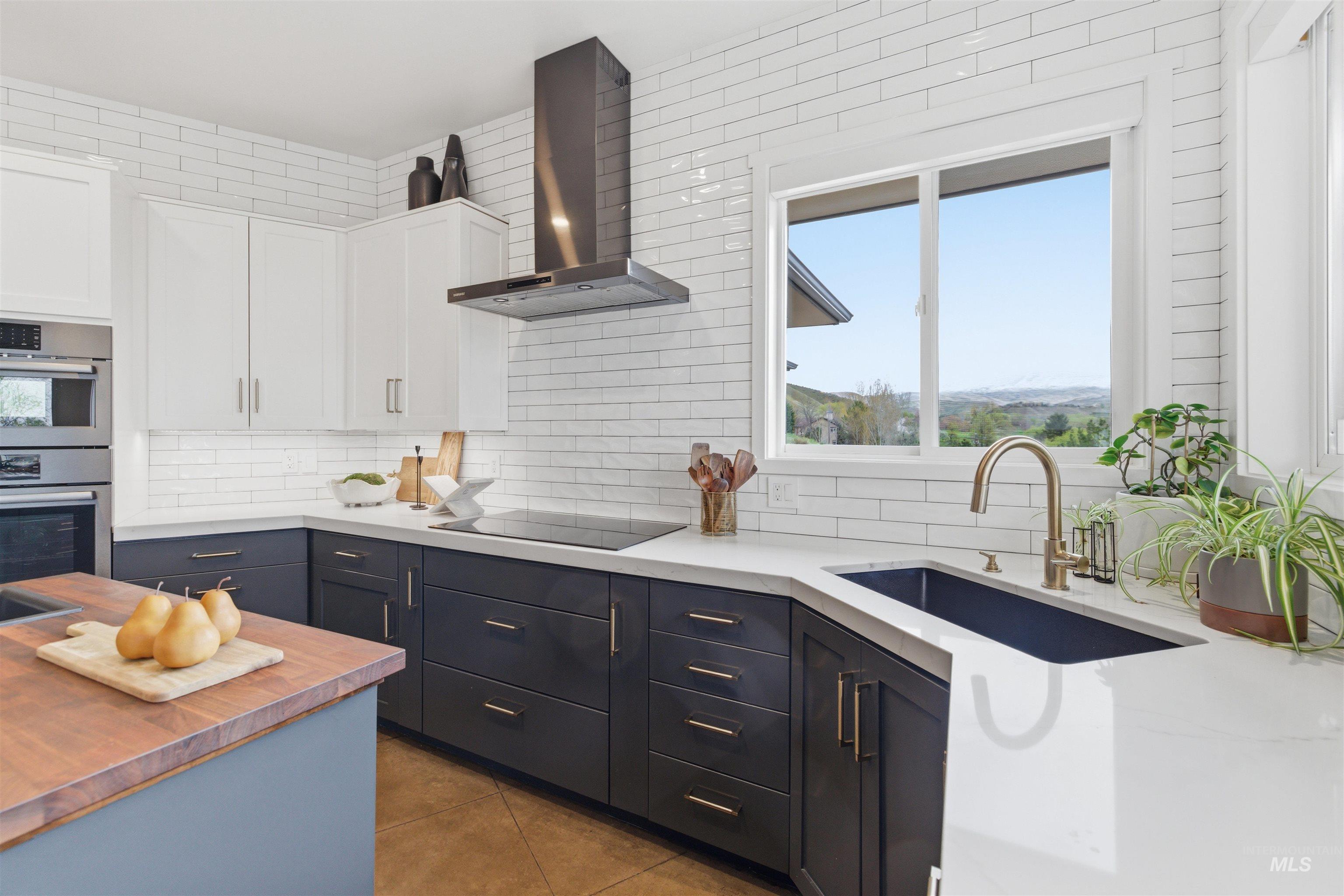 4275 36th Street Boise, ID 83703 - Photo 5 of 50 Kitchen with two tone cabinetry, double oven, dark tile patterned floors, backsplash, and light stone countertops