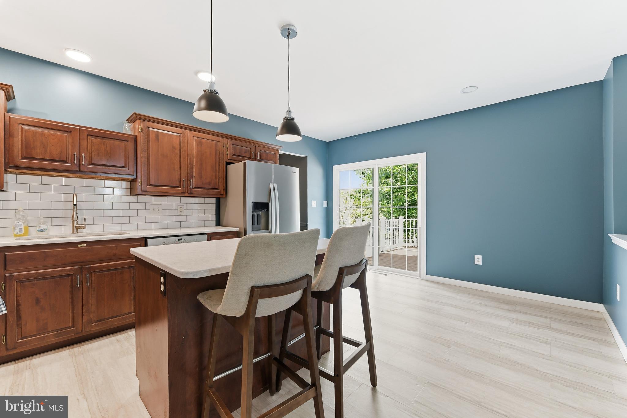 3121 South Wagner Circle Sinking Spring, PA 19608 - Photo 6 of 30 a kitchen with stainless steel appliances granite countertop a kitchen island a stove a table and chairs