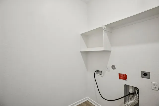 a view of a room with wooden floor and window