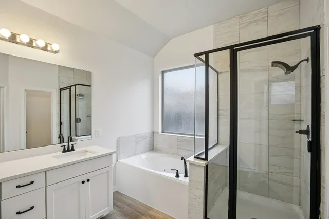 a bathroom with a bathtub and a shower