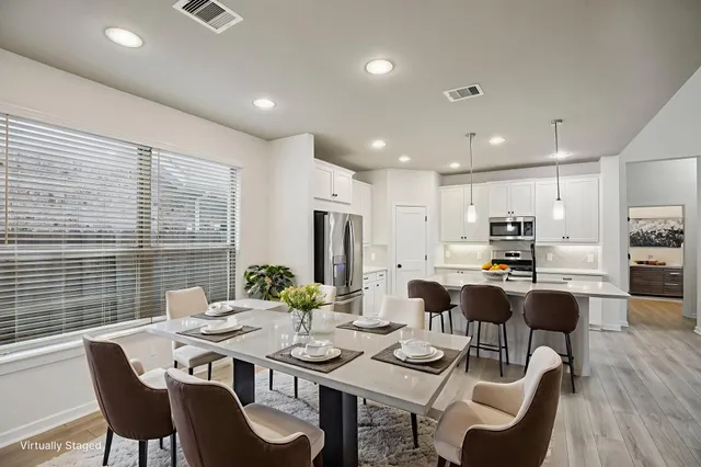 an empty room with wooden floor ceiling fan and windows