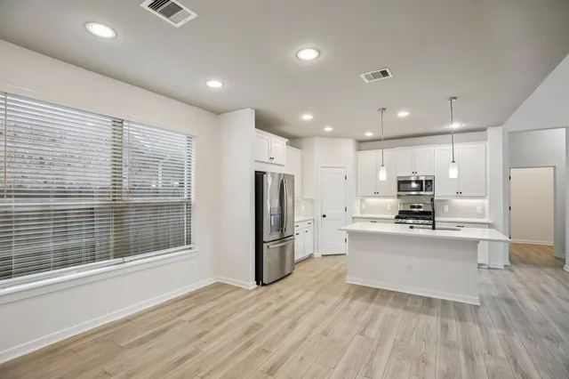 a bathroom with a tub a sink and mirror