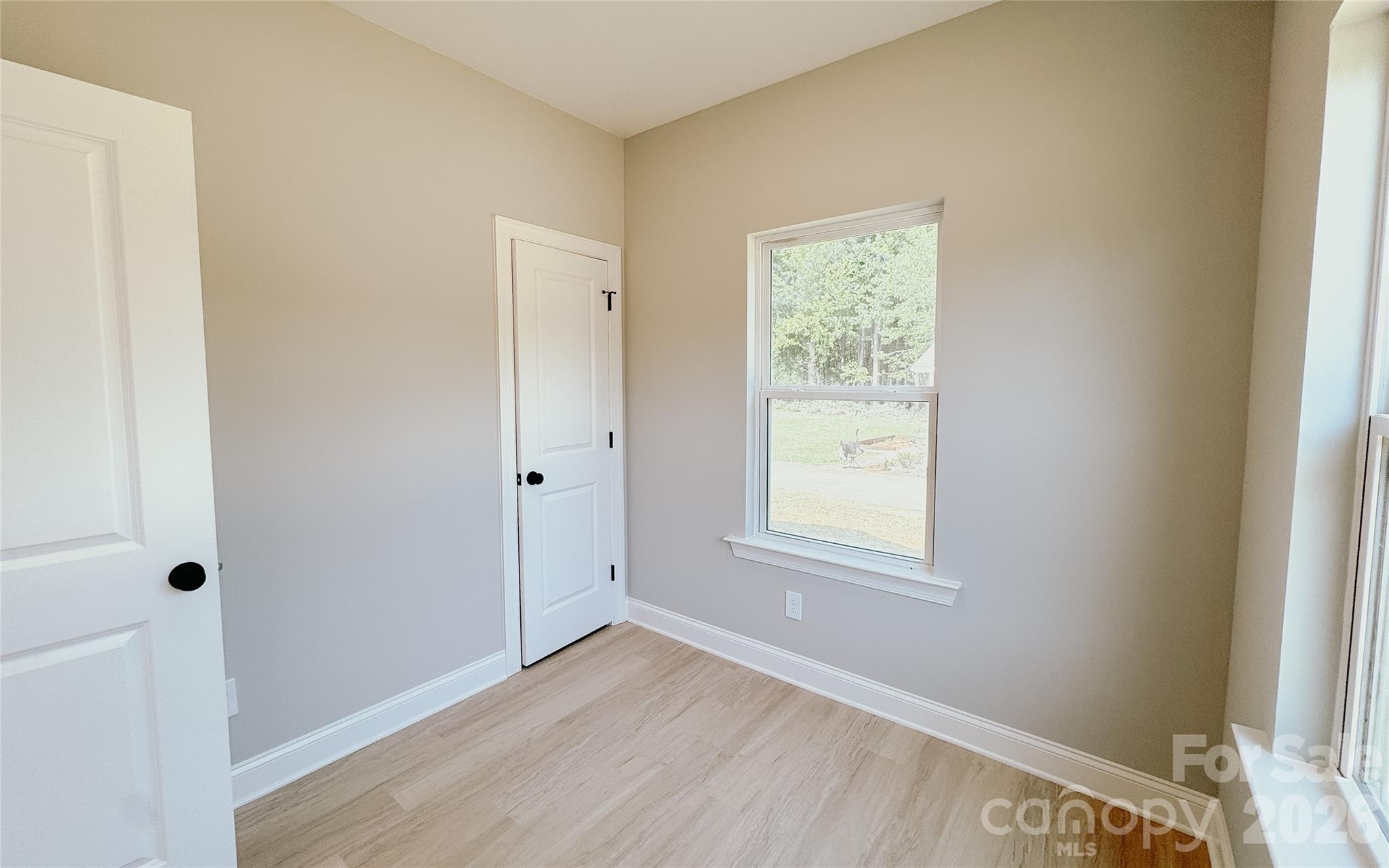 1455 West Ridge Road Salisbury, NC 28147 - Photo 11 of 26 a view of an empty room with wooden floor and a window
