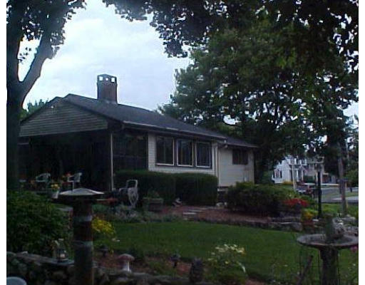 a front view of house with a garden