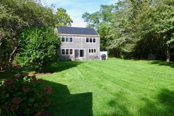 44 Music Street West Tisbury, MA 02568 - Photo 11 of 12 a view of a house with a yard and sitting area