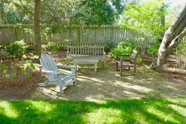 a view of a bench in the garden near a lake