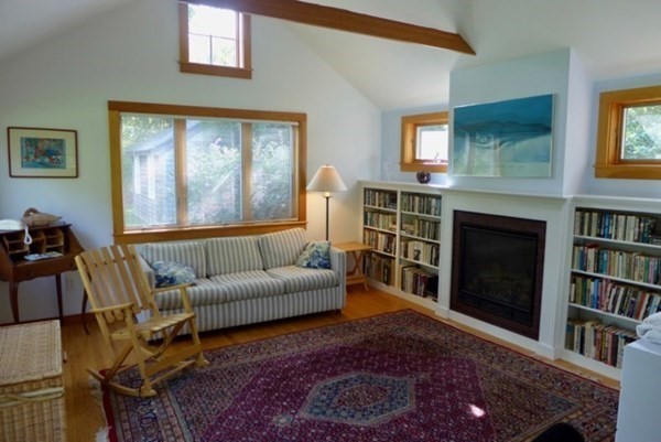 44 Music Street West Tisbury, MA 02568 - Photo 9 of 12 a living room with furniture a bookshelf and a fireplace
