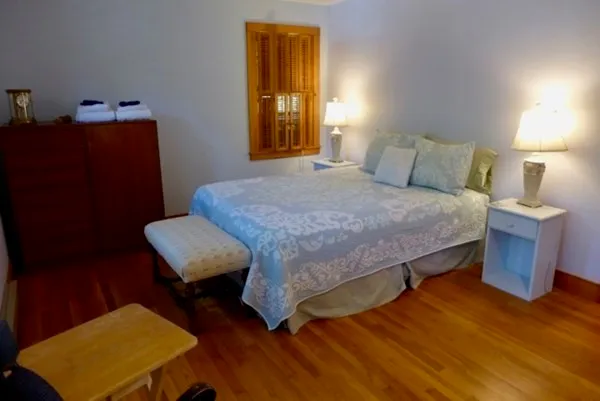 a bedroom with a bed and a dresser in it