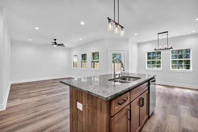a kitchen with stainless steel appliances granite countertop a stove and a sink