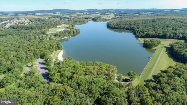 an aerial view of a houses with a yard