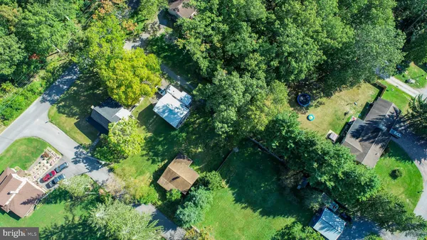 an aerial view of a house with yard