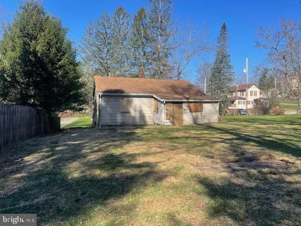 a view of a house with a yard and tree s