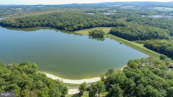 an aerial view of residential house with outdoor space and trees around