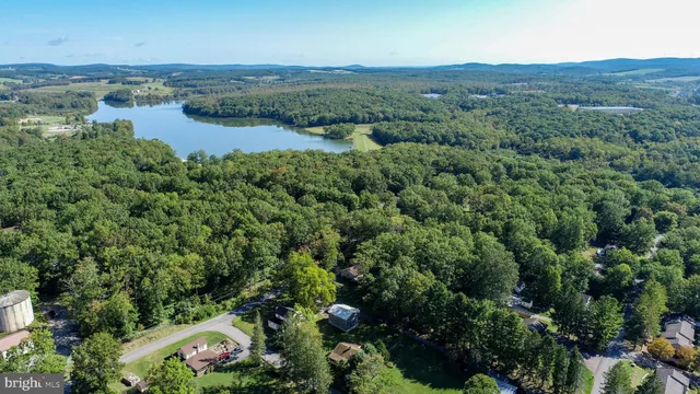 an aerial view of a houses with a lake view
