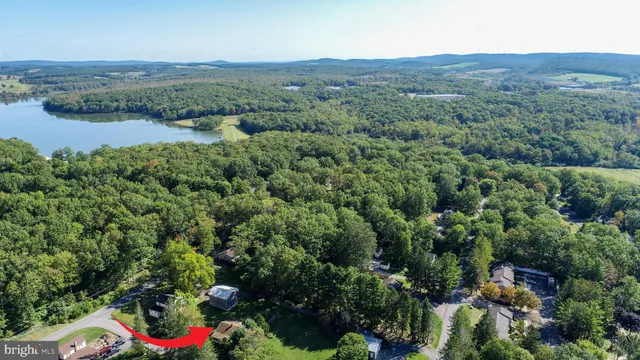 an aerial view of residential house with outdoor space and trees