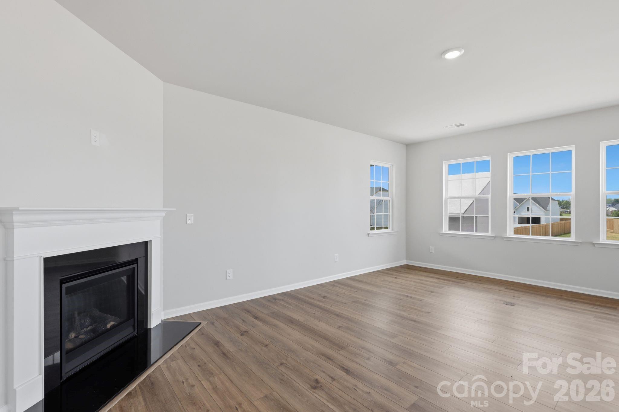 5475 Redbud Road, Unit 57 Lancaster, SC 29720 - Photo 10 of 30 a view of empty room with wooden floor and fireplace