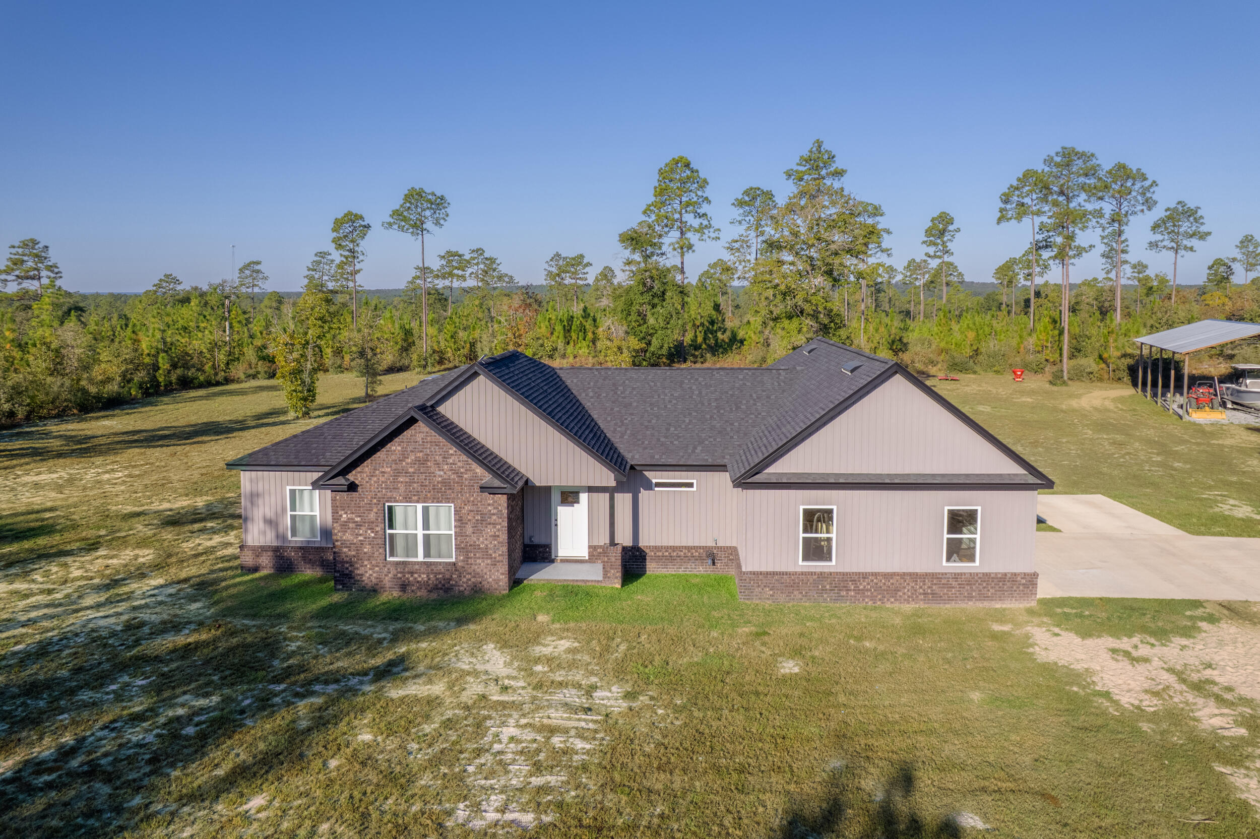 6150 Sherman Kennedy Road Baker, FL 32531 - Photo 1 of 43 a view of a house with a big yard plants and large tree
