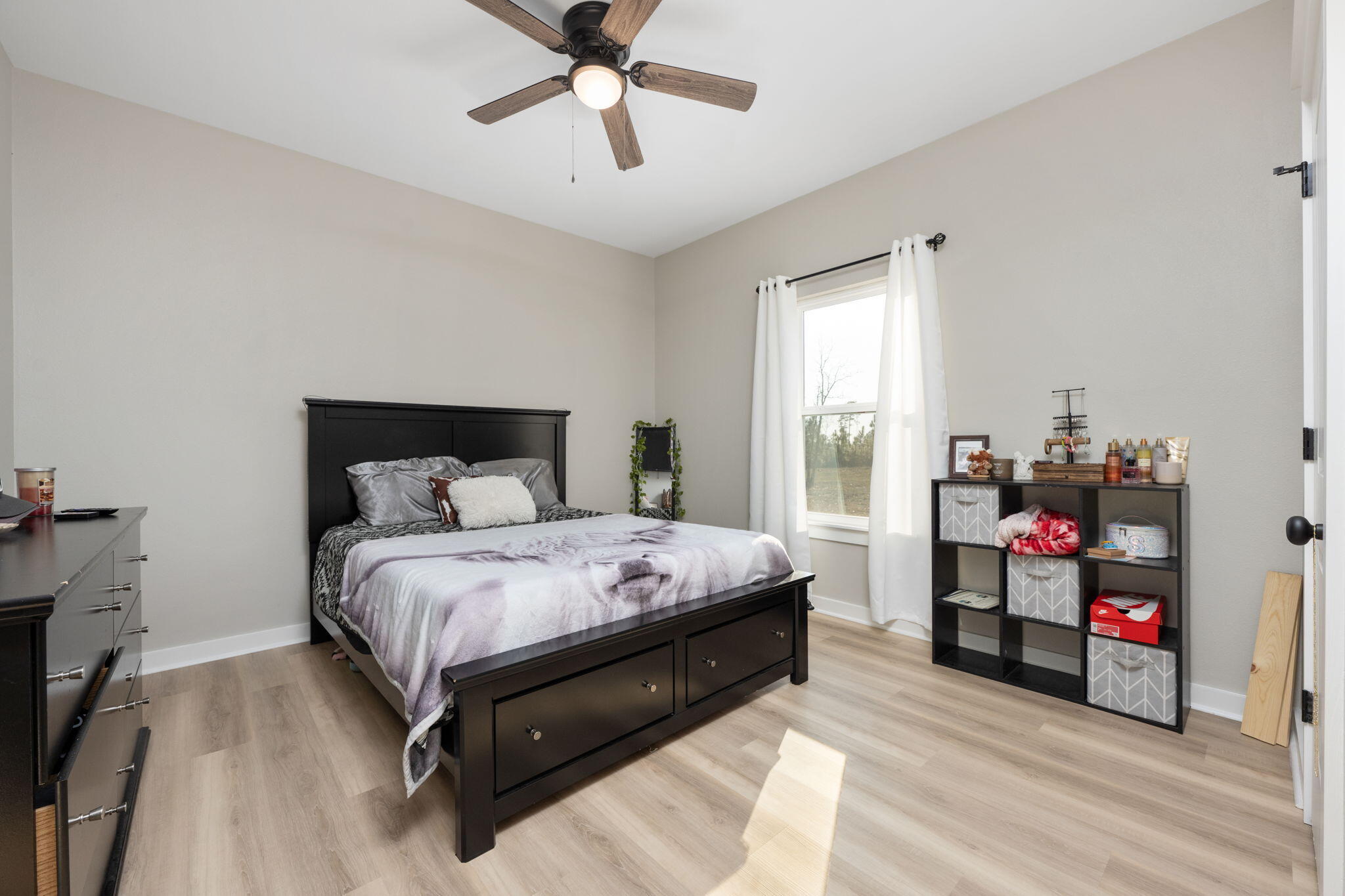 6150 Sherman Kennedy Road Baker, FL 32531 - Photo 11 of 43 a bedroom with a bed and a chandelier