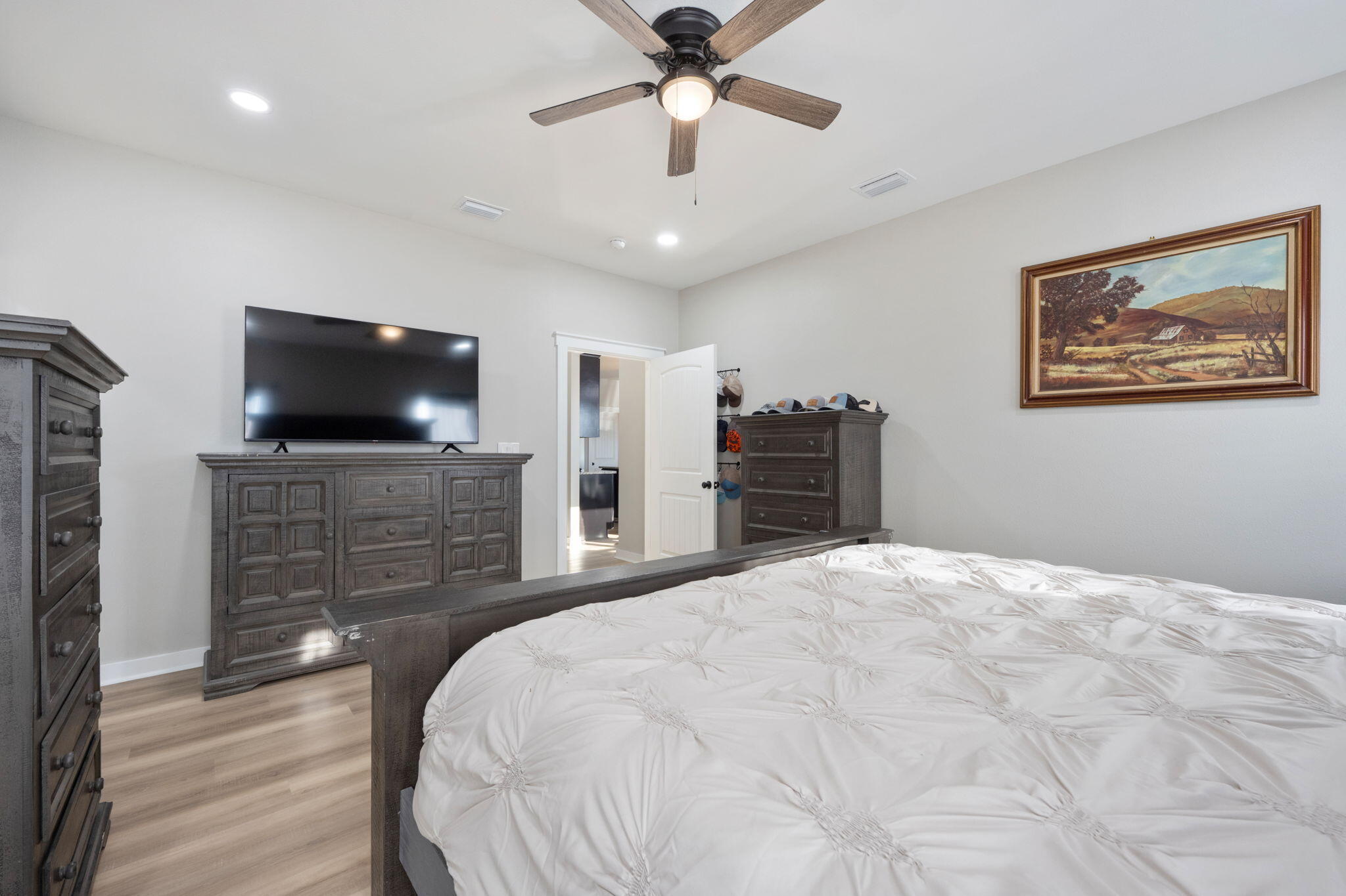 6150 Sherman Kennedy Road Baker, FL 32531 - Photo 16 of 43 a bedroom with a bed and a flat screen tv