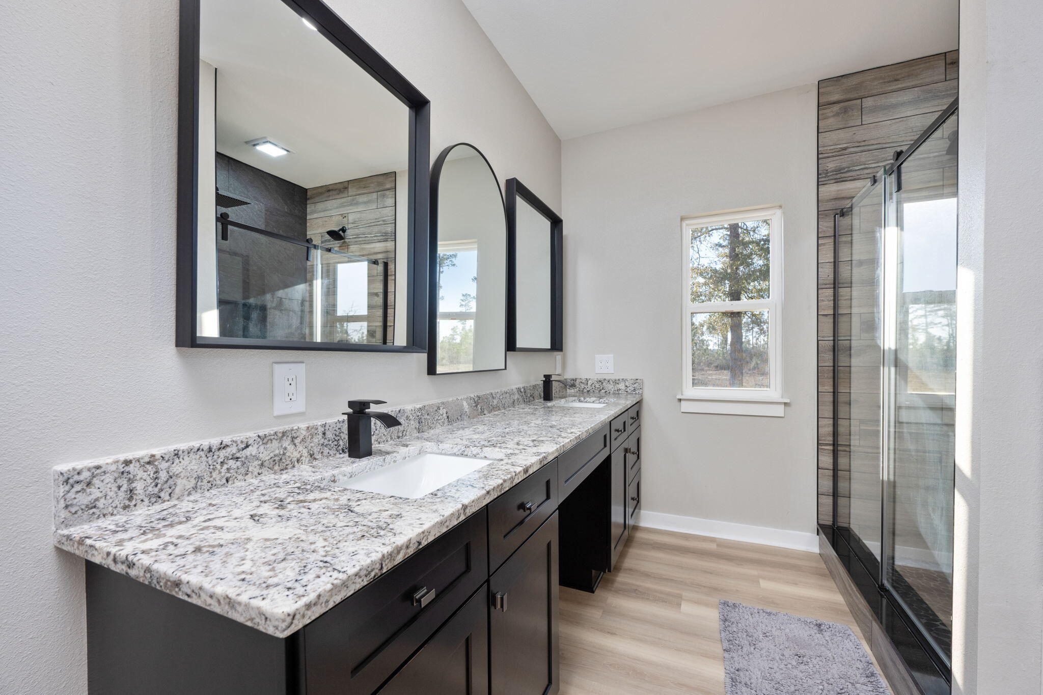 6150 Sherman Kennedy Road Baker, FL 32531 - Photo 18 of 43 a bathroom with a granite countertop sink and a mirror