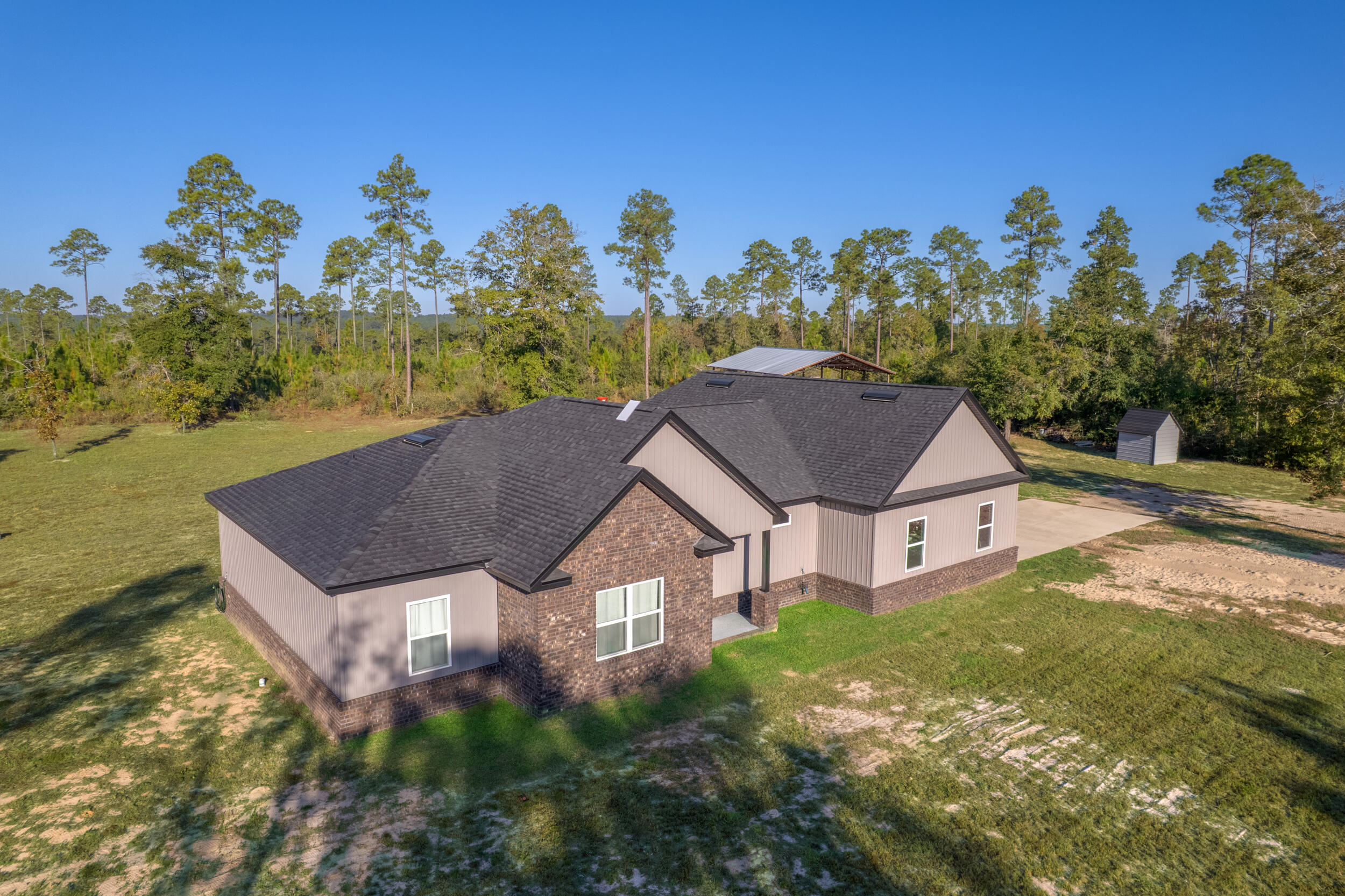 6150 Sherman Kennedy Road Baker, FL 32531 - Photo 2 of 43 a aerial view of a house with a yard basket ball court and outdoor seating