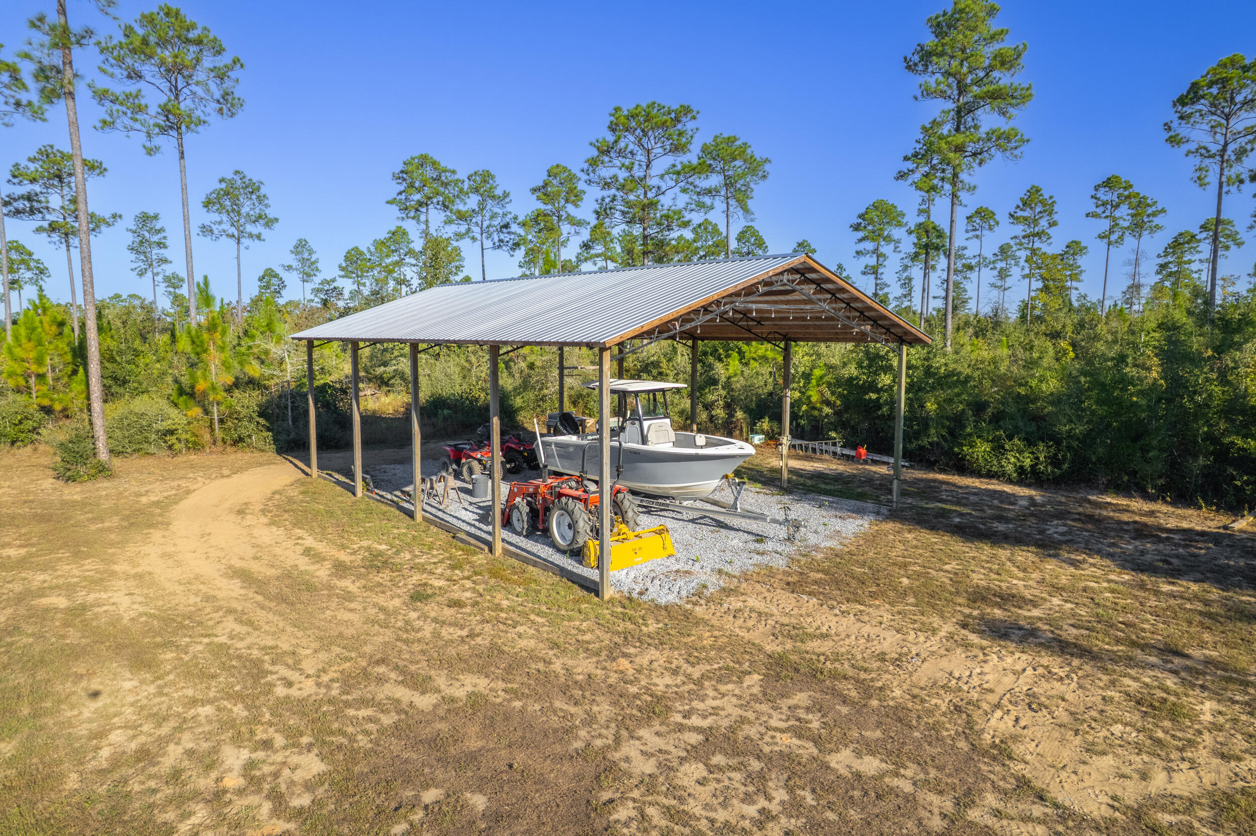 6150 Sherman Kennedy Road Baker, FL 32531 - Photo 27 of 43 a view of a swimming pool with a patio