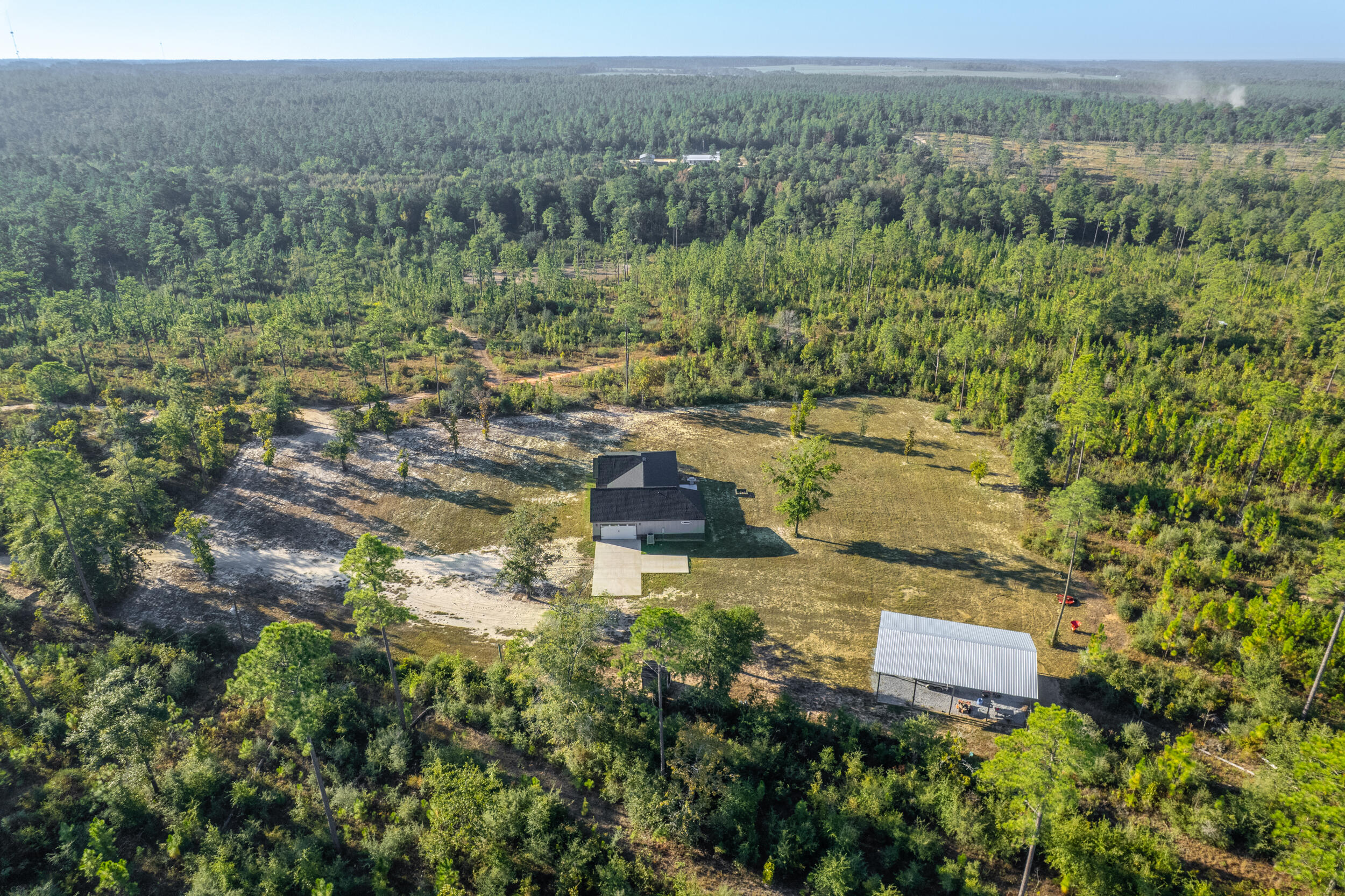 6150 Sherman Kennedy Road Baker, FL 32531 - Photo 33 of 43 an aerial view of residential house with outdoor space and trees all around